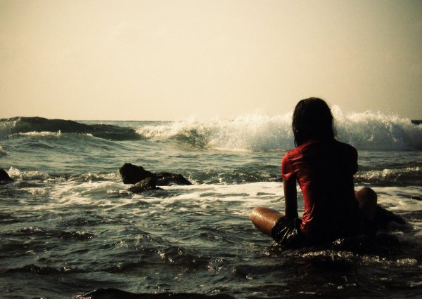 Девушка на берегу моря спиной