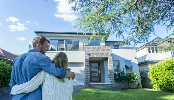 couple in front of house